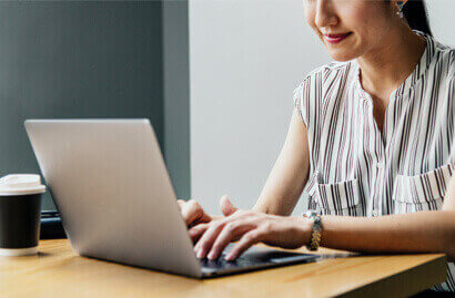 Woman working on laptop at table