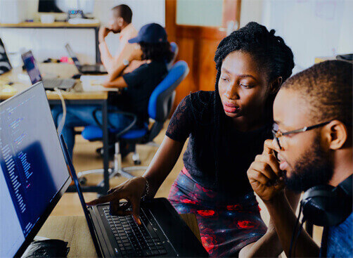 A girl and a boy are working on a computer